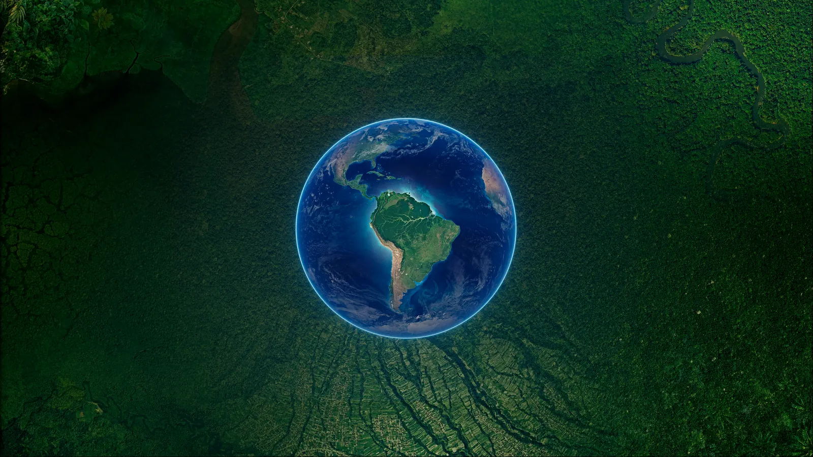 Earth seen from space, the Americas turned towards us, held inside an aerial view of Amazon forest cut through by roads and clearings