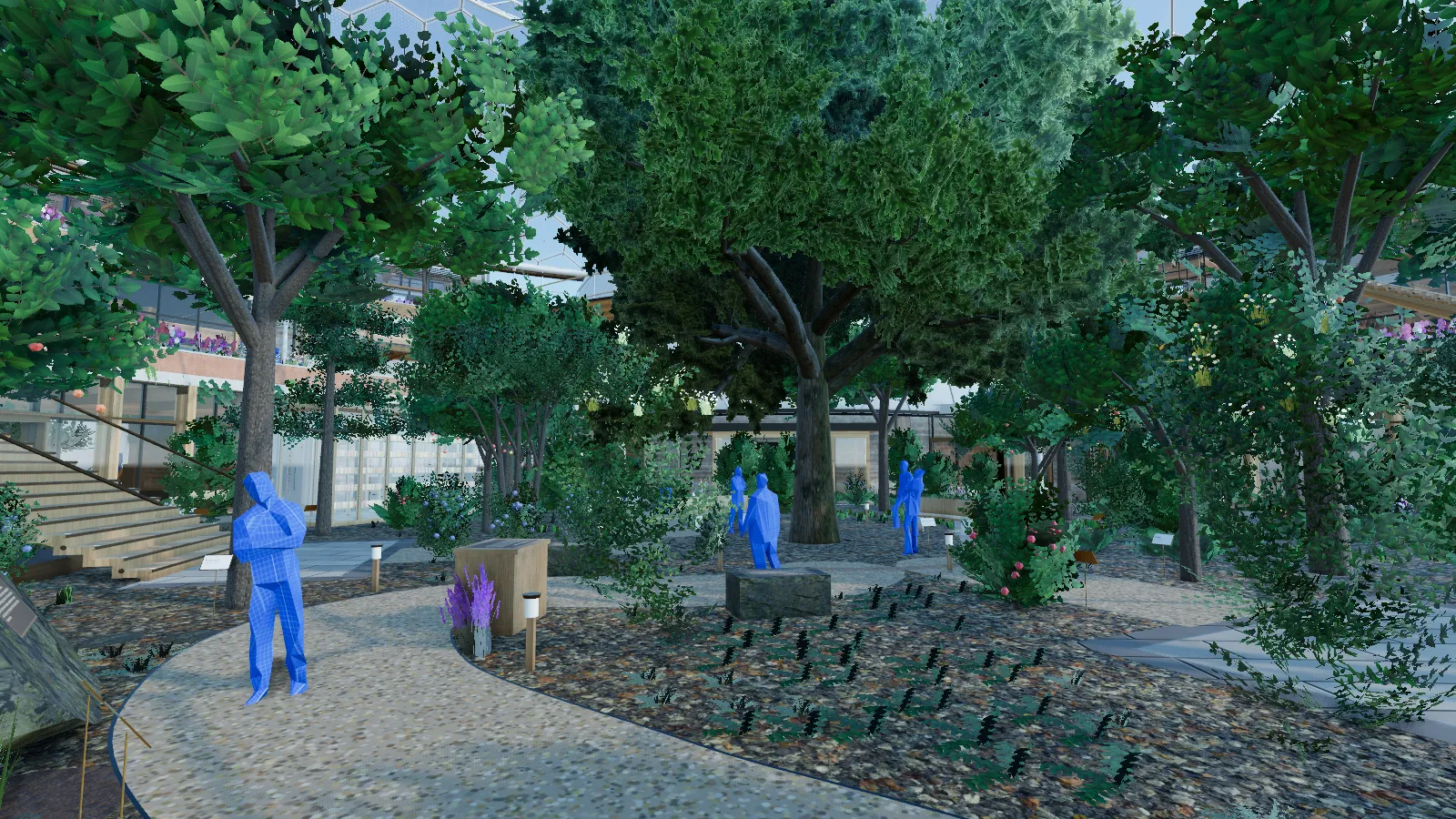A gravel trail curves through dense layered planting toward a great oak, a bronze plate set low beside the path.